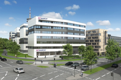 Multi-storey office building with BITMARCK signage at an intersection, cars and pedestrians